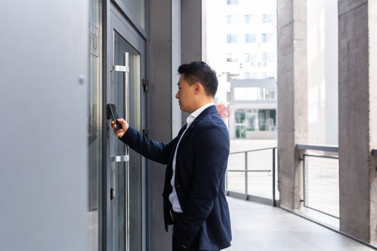 Young male using access control in commercial security solutions in new york city